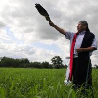 Tribal elder Gordon Yellowman uses an eagle wing in a ritual he performs as a sun dance priest for the Cheyenne-Arapaho tribe in El Reno, Oklahoma, on June 12.  | REUTERS