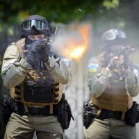 Ukrainian special forces fire their weapons during training in Kharkiv on Friday. As the crisis in the country festers, the United States is quietly considering deploying more of its own special forces to Eastern Europe. | AP