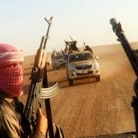 This image grab taken from a video uploaded on June 8 by the jihadist group the Islamic State of Iraq and Syria allegedly shows militants driving in vehicles near the central Iraqi city of Tikrit. | AFP-JIJI