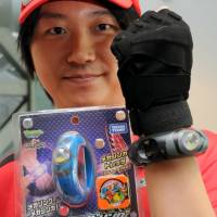 Tomy’s Pokemon Mega Ring is seen being demonstrated Tuesday. | SATOKO KAWASAKI