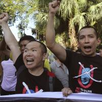 Vietnamese protesters chant anti-China slogans in Hanoi on Thursday, when China said it is moving a second oil rig closer to Vietnam\'s coast. Vietnamese authorities broke up a small protest against the move on Thursday. | AP