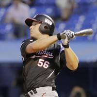 Big introduction: Chiba Lotte\'s Chad Huffman hits a home run in the third inning of the Marines\' 10-3 win over the Swallows on Monday night at Jingu Stadium. | KYODO