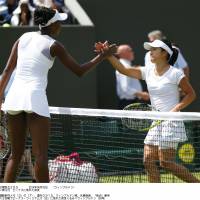 Well played: Kurumi Nara (right) shakes hands with Venus Williams after their second-round match at Wimbledon on Wednesday. Williams won 7-6 (7-4), 6-1. | KYODO