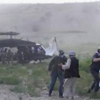 U.S. Army Sgt. Bowe Bergdahl (second from right) is led to a military helicopter at the Afghan border in a screen grab from a video shot by the Taliban and released Wednesday. | REUTERS