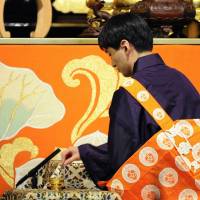 Kojun Otani, 36, the new chief priest of Nishi Honganji Temple in Kyoto, attends a ceremony Friday to succeed his 68-year-old father, Koshin. An estimated 8,000 priests and followers attended the service, the first held since 1977. | KYODO