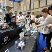 Christmas in June: Visitors check out the thousands of new toys, gadgets and games at the International Tokyo Toy Show on Thursday. | YOSHIAKI MIURA