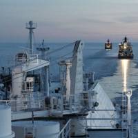Led by icebreakers, liquefied natural gas tankers operated by Russia\'s Gazprom sail in the Arctic Ocean toward Japan in 2012. Mitsui O.S.K. Lines Ltd. plans to begin regular, year-round shipments of LNG via the Arctic route in 2018. | GAZPROM/KYODO