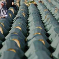 A Muslim woman cries near the casket of her relative in the village of Kozarac, Bosnia, before a reburial of 284 newly identified bodies that were put to rest in several local cemeteries Sunday. The majority of the 284 bodies were excavated from a mass grave in the village of Tomasica in 2013 and identified as those belonging to Bosnian non-Serbs that went missing in 1992, only to be found buried in several mass grave locations years after the war ended. | AP