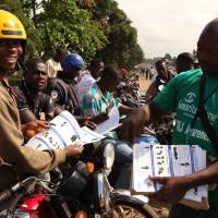 A Samaritan\'s Purse team member hands out pamphlets to educate the public on the Ebola virus in Monrovia,  An isolation unit for Ebola victims in Liberia\'s capital is overrun with cases and health workers are being forced to treat up to 20 new patients in their homes, government officials said Tuesday. | REUTERS