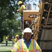Road crew foreman Juan Gomez, who came to America from Mexico in 1996, works on a project for Silver Star Construction in Oklahoma City on Wednesday. Tide of poor migrants floods Texas border
