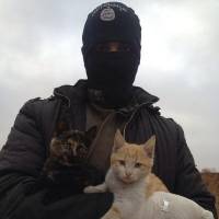 An image from Twitter purportedly shows an Islamic State militant. The winter clothing suggests the photo predates the current offensive in Iraq. | @ISILCATS