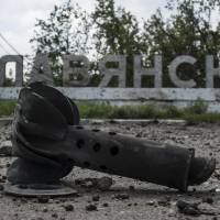 Part of a mortar shell is seen in front of a sign that reads \"Slovyansk,\" after heavy fighting between pro-Russian fighters and Ukrainian government troops just outside the eastern city on Wednesday. The rebels fled Slovyansk, a former stronghold, over the weekend after Kiev troops mounted an offensive, leaving behind a city heavily damaged by fighting and riven by vehemently differing views about its future. | AP
