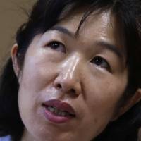 Misa Morimoto cries in Otsuki, Yamanashi Prefecture, on July 15, as she recounts the story of her identical twin Miho, who vanished from their home in Kofu in 1984. | REUTERS