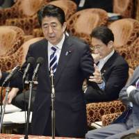 Prime Minister Shinzo Abe addresses questions about the recent Cabinet decision to allow Japan to use the right of collective self-defense, during a special Lower House session on Monday. | AP