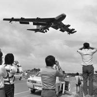 A B-52 bomber flies over the U.S. military\'s Kadena Air Base in Okinawa Prefecture in May 1976. | KYODO