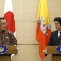 Bhutan Prime Minister Tshering Tobgay and Prime Minister Shinzo Abe address reporters following their meeting in Tokyo on Monday. | AP