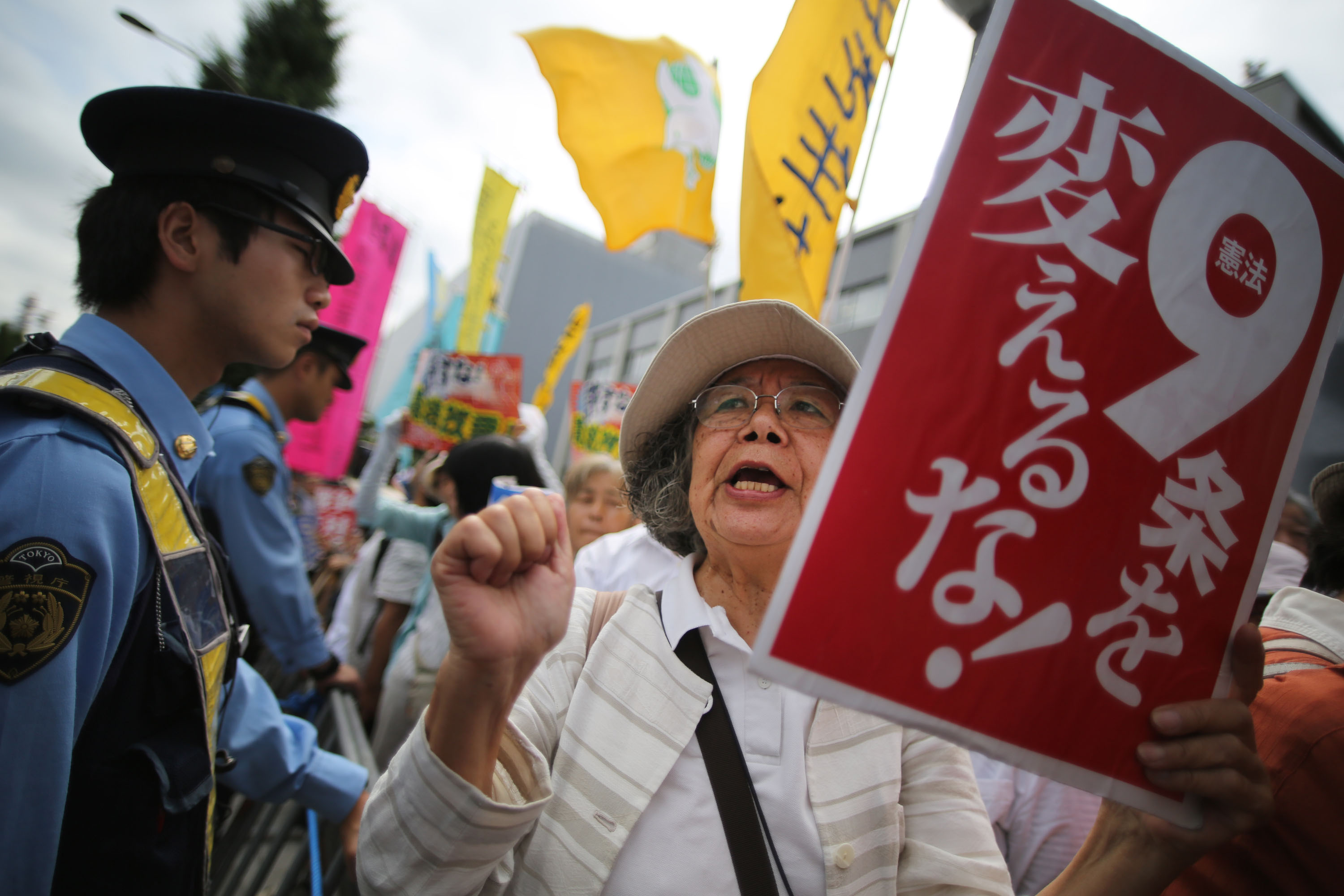 Protesters gather outside the prime minister's office in Tokyo on Tuesday, as the Cabinet prepared to authorize a historic reinterpretation of the Constitution to allow the right to collective self-defense. | AP