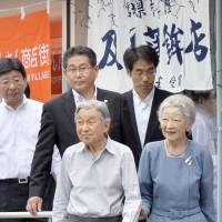 Emperor Akihito and Empress Michiko visit a shopping center in the town of Minamisanriku, Miyagi Prefecture, on Wednesday. | KYODO