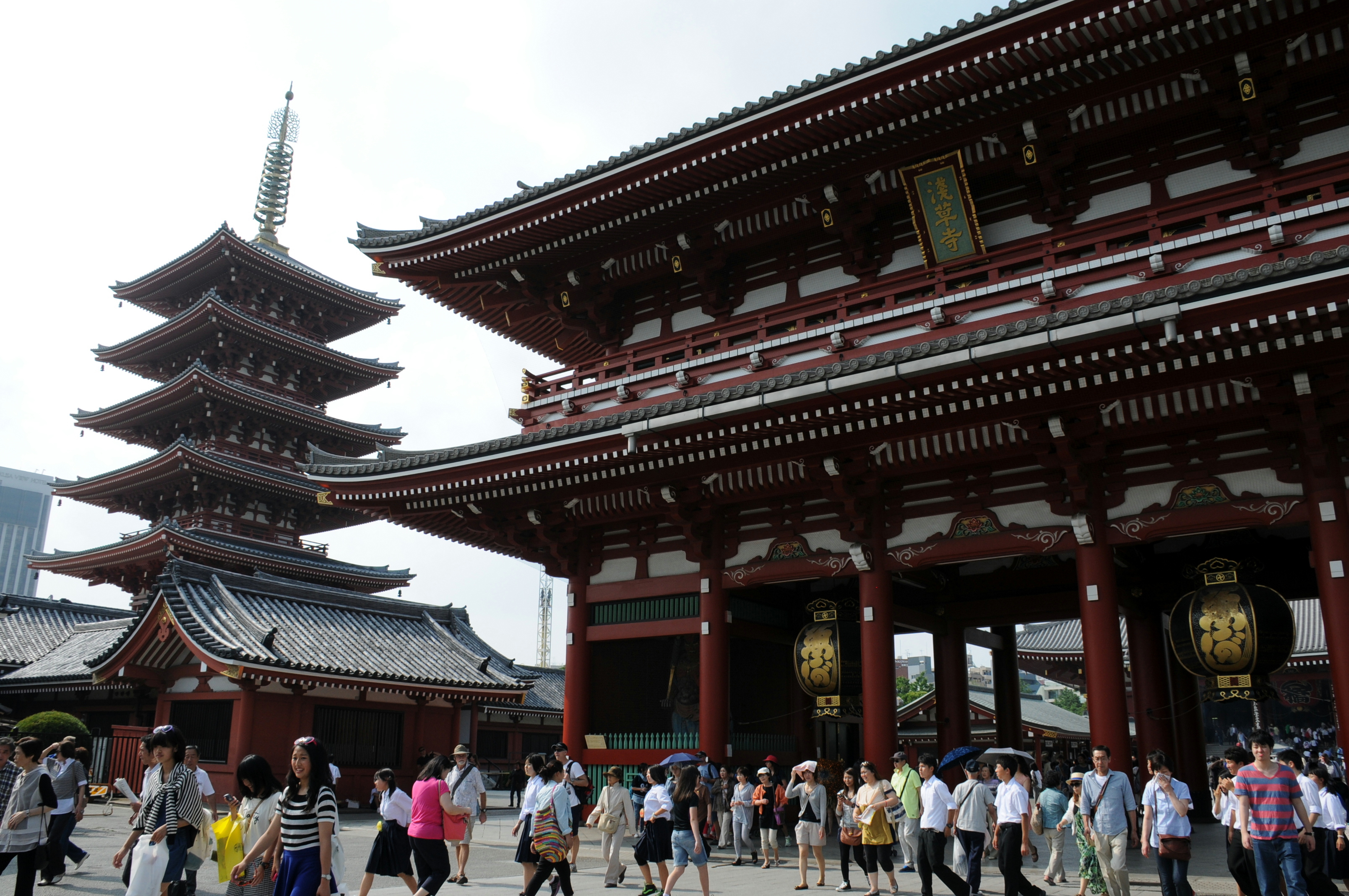 Tourists take in Sensoji Temple's five-story pagoda and Hozomon Gate in Taito Ward, Tokyo. | SATOKO KAWASAKI
