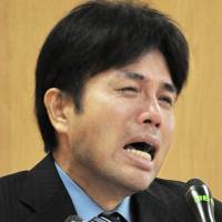 Ryutaro Nonomura, a member of the Hyogo Prefectural Assembly, cries during a press conference in Kobe on July 1 after being questioned about his expense reports. | KYODO