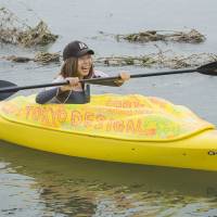 Japanese artist Megumi Igarashi, known as Rokudenashi-ko, paddles in her kayak modeled on her vagina in Tama River in Tokyo Oct. 19, 2013. Igarashi, 42, says she was challenging a culture of \'discrimination\' against discussion of the vagina in Japanese society. | REUTERS