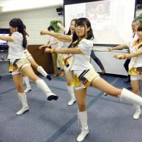 Girl idol group LinQ shows off gymnastic exercises designed to help the elderly avoid physical problems during a demonstration earlier this month in the city of Fukuoka. | KYODO