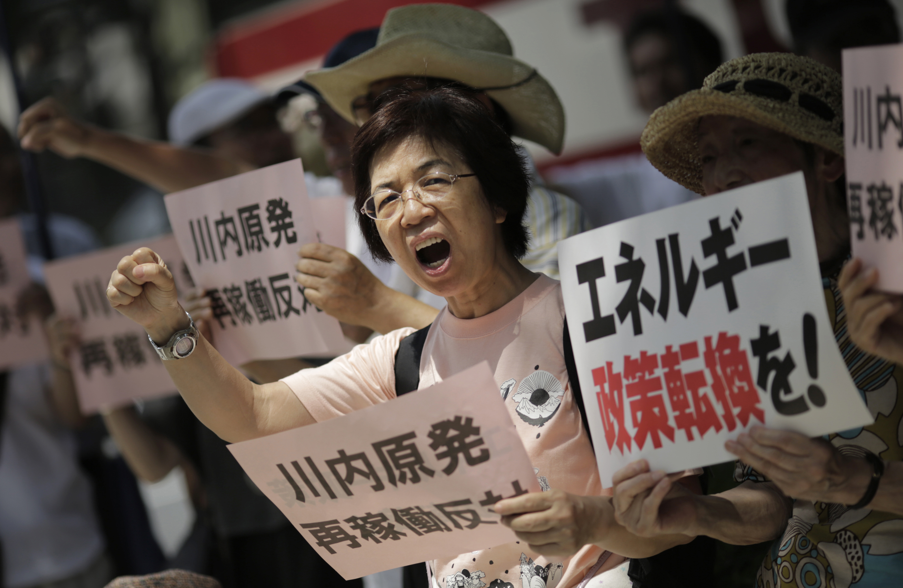 Demonstrators in Tokyo protest on Wednesday against the NRA’s preliminary approval of reactor restarts at the Sendai plant. | AP