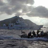 Japanese Coast Guard vessels patrol near the disputed Senkaku Islands last August. | AP