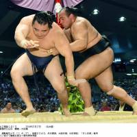 Stepping stone: Egyptian maegashira Osunaarashi (right) overpowers Kakuryu on Thursday at the Nagoya Grand Sumo Tournament, beating a yokozuna for the first time. | KYODO