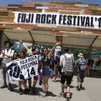 Let’s go: A group of music fans arrive at the gates of this year’s Fuji Rock Festival in Naeba, Niigata Prefecture, on Friday. Two weddings and a 'Funeral' at Fuji