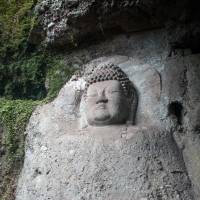 Time scarred: One of the great rock carvings at Kumano magaibutsu, said to be  from the eighth century. | STEPHEN MANSFIELD