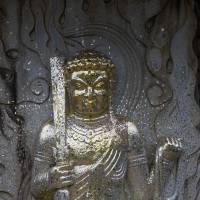 Visitors to Taizoji Temple can buy gold flakes and press them onto this statue as a traditional offering. | STEPHEN MANSFIELD