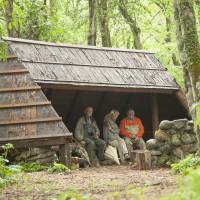 Big day out: Wildlife artist and environmentalist Robert Bateman (far left), his wife, Birgit, and Old Nic take shelter from the rain during the Batemans\' recent visit to the woods of Nagano Prefecture. | C.W. NICOL