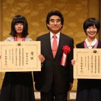Shiho Fukushima (left) and Shiho Soma (right) pose with Haruhisa Handa, the chairman of the International Foundation for Arts and culture, after receiving Prime Minister Awards at a Tokyo hotel July 5. Young artists grow through international exchange