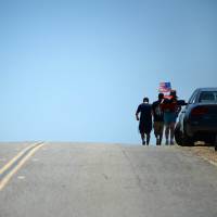 Protesters leave an anti-illegal immigration protest outside a US Border Patrol facility in Murrieta, California, on Monday. | AFP
