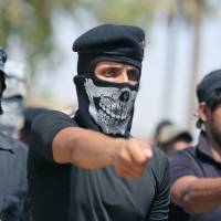 Shiite Muslim volunteers march in Baghdad on Wednesday as they join the Iraqi army to fight against jihadist militants. | AFP