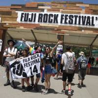 A group of music fans arrive at the gates of this year\'s Fuji Rock Festival in Naeba, Niigata Prefecture, on Friday. The yearly festival is well-known overseas and features musicians from a variety of genres. This year\'s lineup of bands includes Arcade Fire, Denki Groove and the Yoko Ono Plastic Ono Band. | CHIEKO KATO