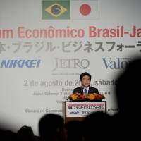 Prime Minister Shinzo Abe delivers a speech during the Brazil-Japan Economic Forum in Sao Paulo on Saturday. Abe signed deals ranging from energy to food and health care during his visit to Latin America’s largest economy. | AP