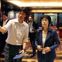 Hokkaido Gov. Harumi Takahashi (right) tours a casino complex on Singapore\'s Sentosa Island, on Monday. | KYODO