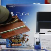 A customer buys a Sony PlayStation 4 at a Bic Camera store in Tokyo in February. | BLOOMBERG
