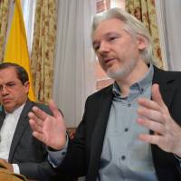 Ecuador\'s foreign minister Ricardo Patino (left) and WikiLeaks founder Julian Assange speak during a press conference Monday inside the Ecuadorian Embassy in London, where Assange confirmed he \"will be leaving the embassy soon.\"  The Australian Assange fled to the embassy in 2012 to escape extradition to Sweden, where he is wanted over allegations of sex crimes. | AP