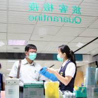 This Aug. 13 photo released by Taiwan\'s Centers for Disease Control shows officials taking part in an exercise at Taoyuan airport outside Taipei, simulating the arrival and isolation of a tourist suspected of carrying the deadly Ebola virus. | AFP-JIJI