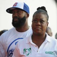 Tracy Martin (left) and Sabrina Fulton, parents of Trayvon Martin, wait to speak during Peacefest, a festival hosted by Better Family Life and the Trayvon Martin Foundation in support of the family of slain teenager Michael Brown in St. Louis, Missouri, on Sunday. | AFP-JIJI