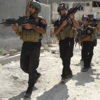 Members of the Iraqi Special Operations Forces conduct a patrol looking for militants of the Islamic State, formerly known as the Islamic State in Iraq and the Levant, in a neighborhood in Ramadi on July 22. | REUTERS