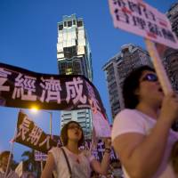 Gaming workers protest outside Casino Grand Lisboa in Macau on Monday. | BLOOMBERG