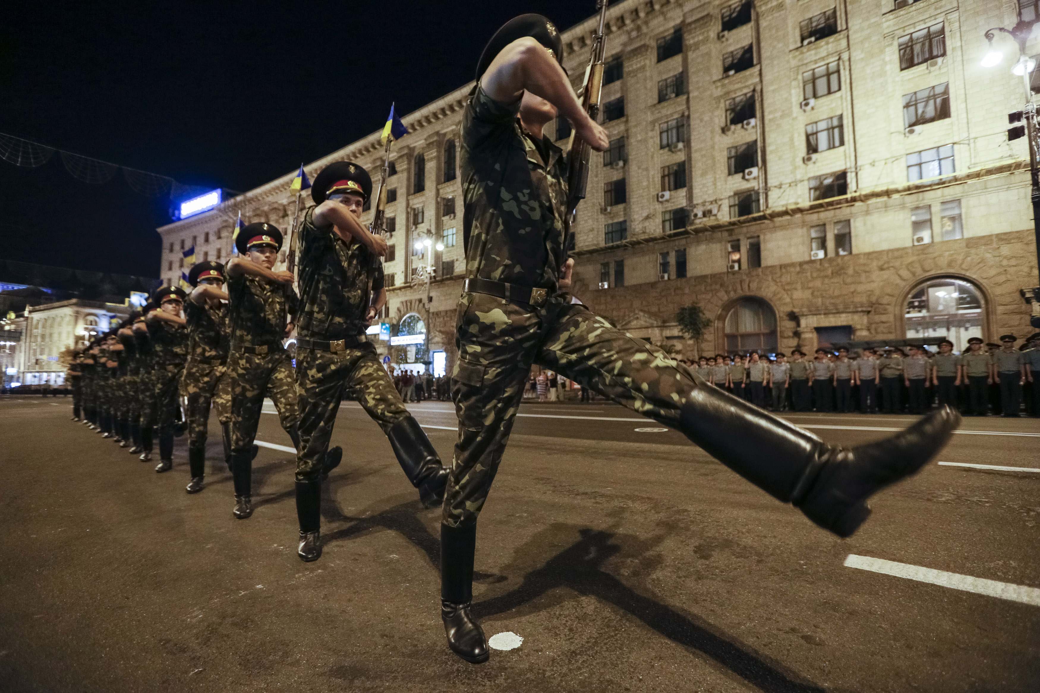 Ukrainian soldiers rehearse in Kiev on Wednesday for an Independence Day parade this weekend. NATO's commander has said the alliance would react militarily if Russian troops infiltrated a member state's territory in the way they apparently did in Crimea. | REUTERS