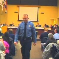 Officer Darren Wilson, whose shooting of a teen sparked protests in Ferguson, Missouri, attends a city council meeting Feb. 11. in footage released by authorities. | AP