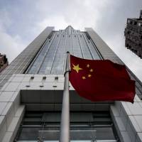 The Chinese national flag flies in front of the Liaison Office of the Central People\'s Government in Hong Kong on Wednesday. | AFP-JIJI
