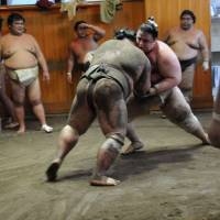 Sumo wrestlers practice at the Kasugano stable in Tokyo\'s Ryogoku district in Sumida Ward on Aug. 21. | SATOKO KAWASAKI