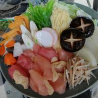 The ingredients for \"chanko nabe,\" including chicken and a variety of vegetables, are displayed in Ryogoku. Nearly 20 chanko restaurants around Ryogoku Station offer the dish, which is the daily staple of sumo wrestlers. | SATOKO KAWASAKI